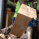 UPS man hands parcel to customer